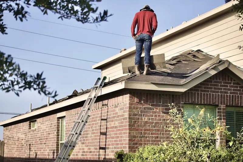 Professional roofer working on a residential roof in Gregory